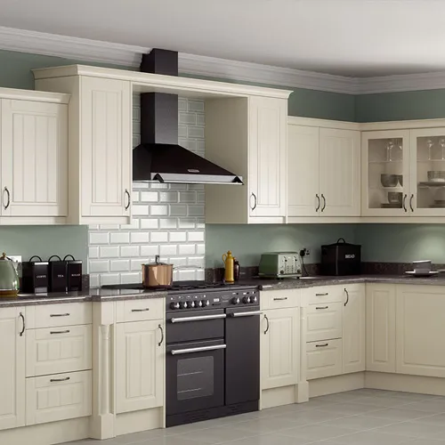 Classic ivory kitchen with framed doors, glazed wall units, a range cooker and a white metro-tile splashback